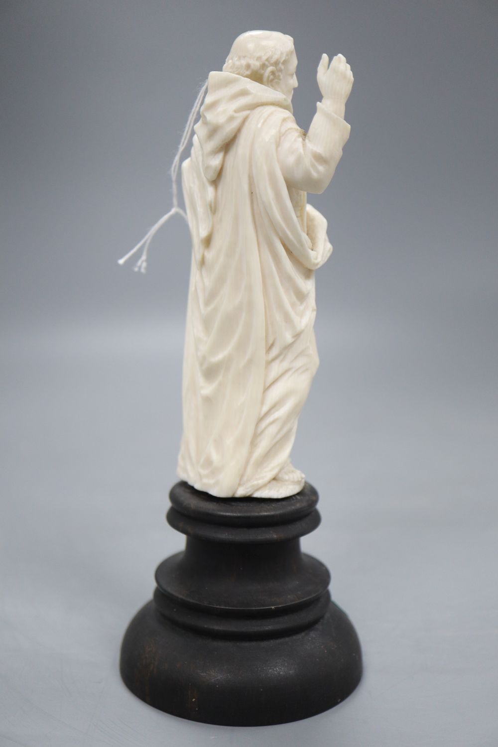 An ivory depiction of the Pope on wooden base, height 17cm